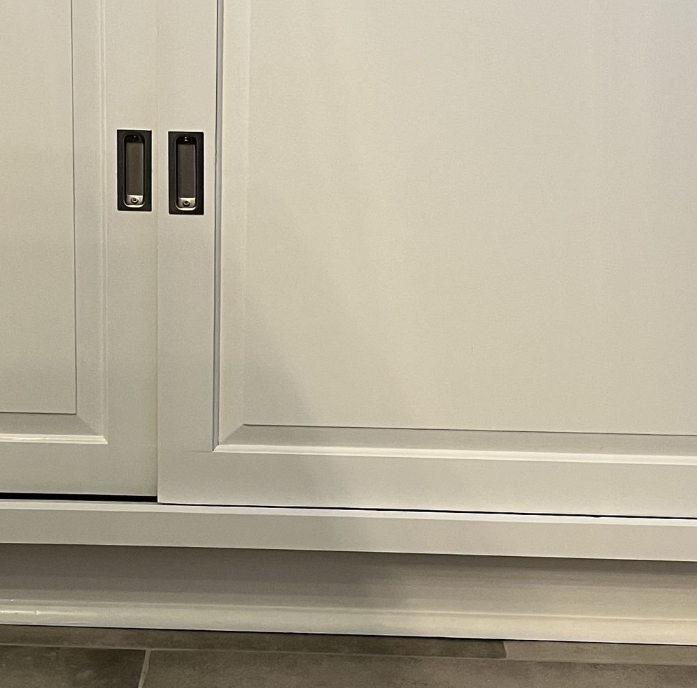 Flush recessed pull set into a painted cabinet door
