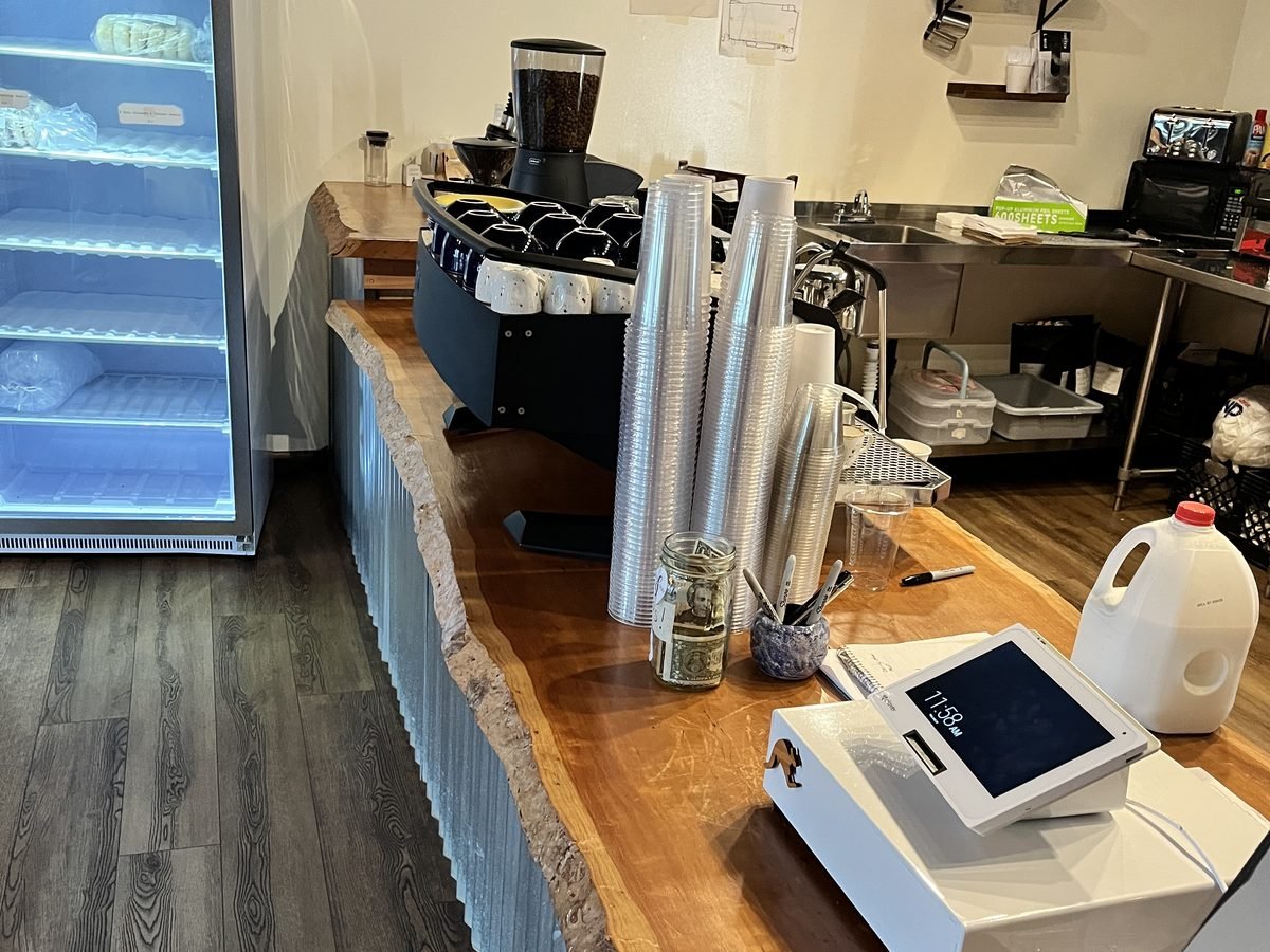 Live-edge service counter running the length of a coffee shop